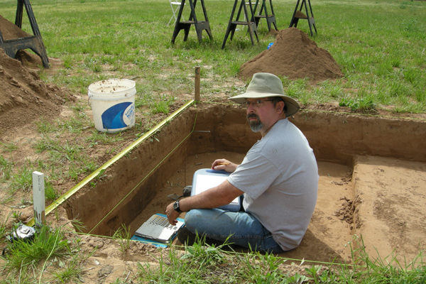 Paul Knapp documenting pit feature