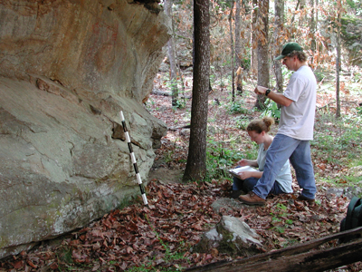 Archeologists studying rock art.