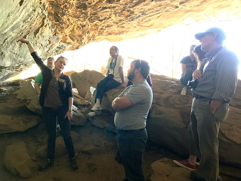 Dr. Horton showing the teacher workshop participants rock art depicting plants on the walls of Rockhouse Cave. 