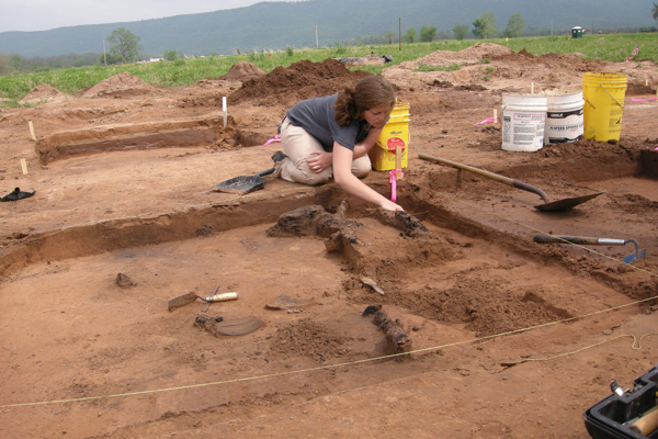Kat Avant excavating charred house timbers