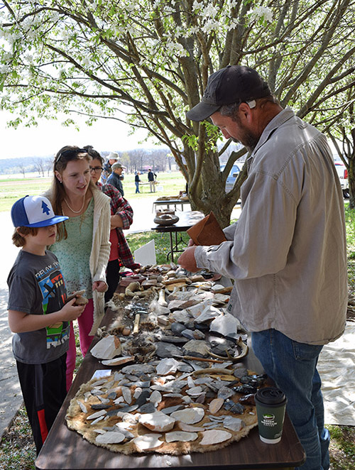 UAF Station Assistant Mike Evans demonstrating flint knapping during Archeology Day 2016 in Fayetteville.