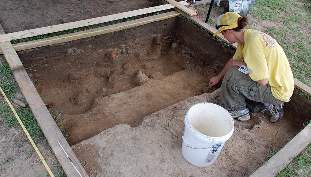 Arkansas Archeological Society member and UA graduate student Michelle Rathgaber excavating in a unt at Historic Washington State park