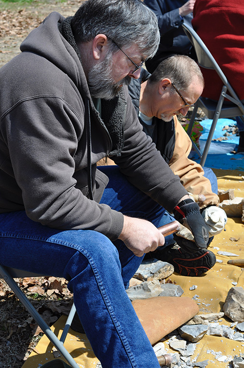 Society member Paul Knapp tries his had at flint knapping.