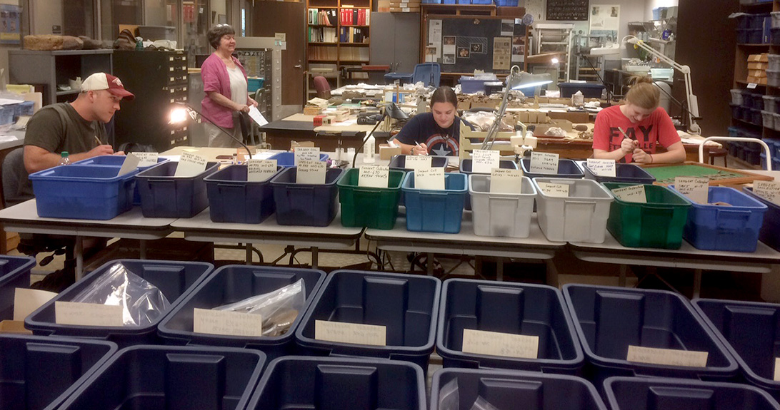 Leanda Gavin (right) and University of Arkansas students Chris Bryant and Katie Sargent were among the two dozen volunteers helping to catalog the Sargent collection.