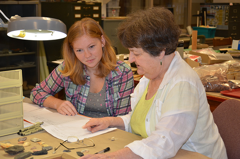 State Archeologist Dr. Ann Early providing cataloging instruction to volunteer Leanda Gavin.