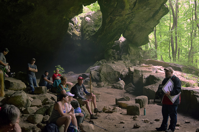 Dr. Jamie Brandon giving a talk about Ozark bluff Shelters in Indian Rockhouse Cave on Panther Creek in the Buffalo National River.  Photo by Lydia Rees.