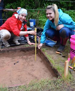 Dr. Carol Colannino teaching 4-H youth how to excavate.