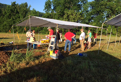 Project Director Tim Mulvihill (red shirt, cap) organizing Society members at 3FR46 field records center.