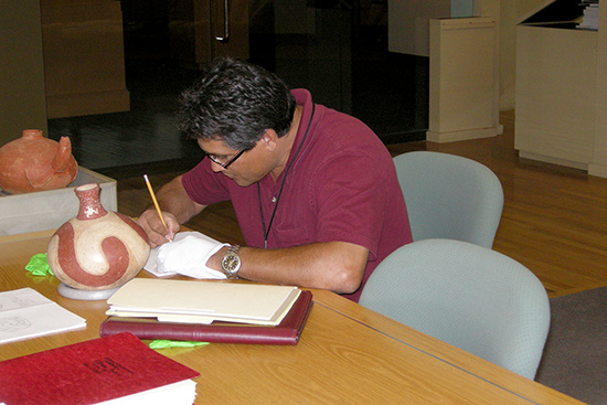 Bobby Gonzales (Caddo Nation NAGPRA Coordinator) documenting Arkansas pottery collections at the Gilcrease Museum in Tulsa.