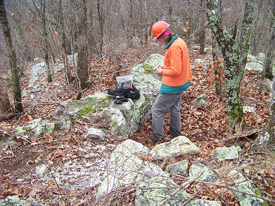 Trubitt documents a quarried trench feature during a visit to a novaculite quarry site in the Ouachita National Forest in 2013.