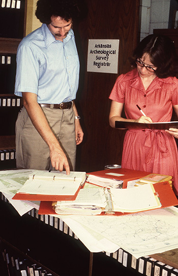 Tim Klinger and Cathy Moore-Jansen (Survey Registrar) look at paper site files in 1979. Major projects can involve over 1,000 sites, making this process laborious if using paper forms. The development of AMASDA allows such projects to be conducted more efficiently.