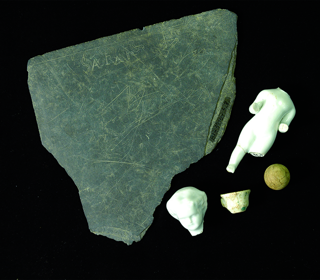 Slate fragment and toys from the Sanders House excavations at Historic Washington Arkansas State Park.