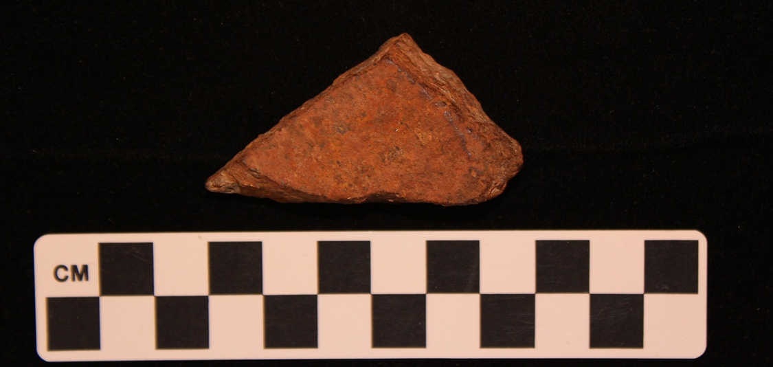 Civil War cannonball fragment with measurement scale.
