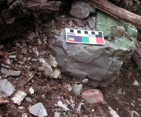 Novaculite boulder and chipping debris in a quarry trench, Montgomery County, Arkansas.