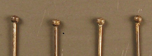 Figure 5. Close-up of straight pin heads showing brass wire wrapped around the shaft.