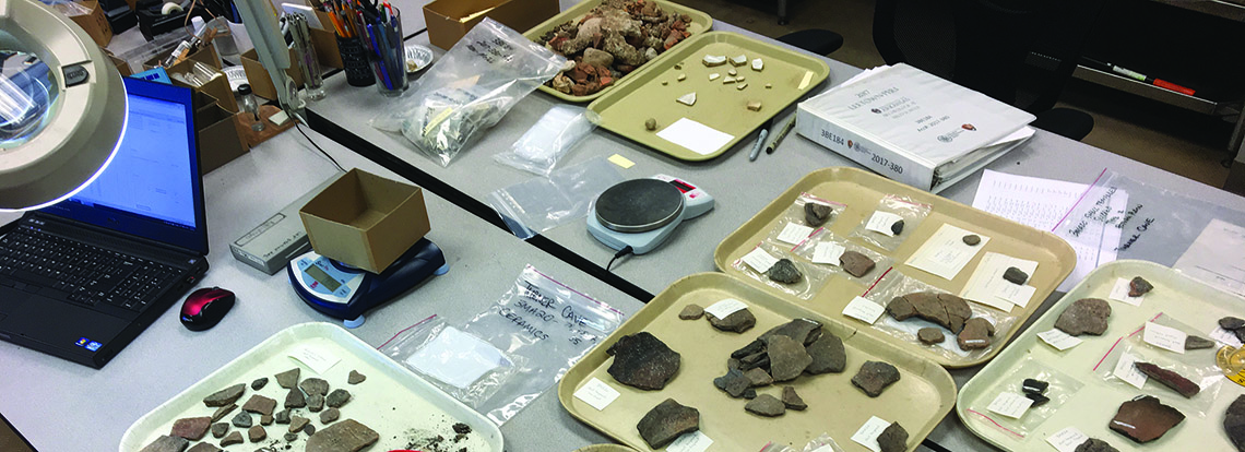 Tablescape: working on Saltpeter Cave maps and projectile points from 1970s excavations, ARAS-UAF digital photo by Jamie Brandon. Tablescape: working on Saltpeter Cave maps and projectile points from 1970s excavations, ARAS-UAF digital photo by Jamie Brandon.