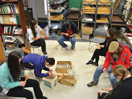 UAFS Introduction to Archeology students learning the process of flintknapping (ARAS-UAFS DSC_1963, Digital Photo by Tim Mulvihill). UAFS Introduction to Archeology students learning the process of flintknapping (ARAS-UAFS DSC_1963, Digital Photo by Tim Mulvihill).