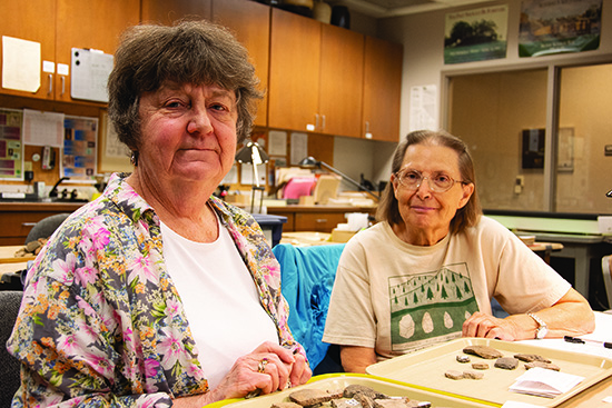 State Archeologist Ann Early with volunteer Pat Corbin in the ARAS lab in 2019. Photo by Rachel Tebbetts. 