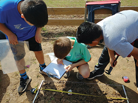 Project Dig kids develop spatial and observational skills by learning how to map artifacts in a grid and record data. Project Dig kids develop spatial and observational skills by learning how to map artifacts in a grid and record data.
