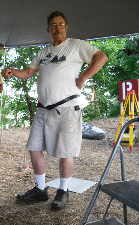 A man standing under a sunshade canopy